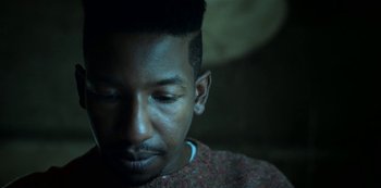 Movie still from “Archive 81” (2022), created by Rebecca Sonnenshine – A person with his eyes closed; Close Up shot, Low angle