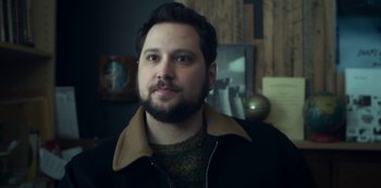 Movie still from “Archive 81” (2022), created by Rebecca Sonnenshine – A person wearing a jacket; Close Up shot, High angle