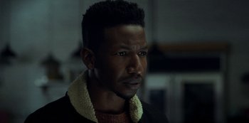 Movie still from “Archive 81” (2022), created by Rebecca Sonnenshine – A person wearing a jacket; Close Up shot, Over the shoulder angle