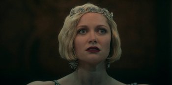 Movie still from “Archive 81” (2022), created by Rebecca Sonnenshine – A person wearing a tiara; Close Up shot, Over the shoulder angle