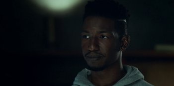 Movie still from “Archive 81” (2022), created by Rebecca Sonnenshine – A person wearing a hooded sweatshirt; Close Up shot, Over the shoulder angle