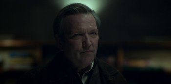 Movie still from “Archive 81” (2022), created by Rebecca Sonnenshine – A person wearing a jacket; Close Up shot, Low angle