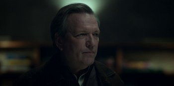 Movie still from “Archive 81” (2022), created by Rebecca Sonnenshine – A person wearing a jacket; Close Up shot, Low angle