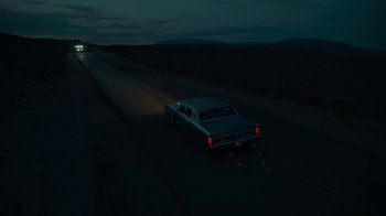 Movie still from “Army of the Dead” (2021), directed by Zack Snyder – A car driving down a road at night; Extreme Wide shot, High angle