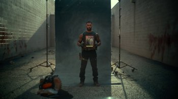 Movie still from “Army of the Dead” (2021), directed by Zack Snyder – A man standing in front of a photo of himself; Medium shot, Over the shoulder angle