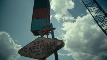 Movie still from “Army of the Dead” (2021), directed by Zack Snyder – A sign that reads " drive carefully come back soon "; Extreme Wide shot, Low angle