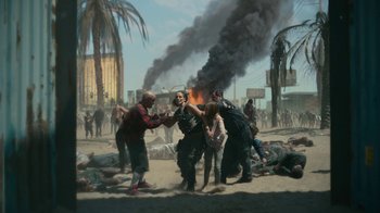 Movie still from “Army of the Dead” (2021), directed by Zack Snyder – A group of people standing in the sand near a fire; Wide shot, Low angle