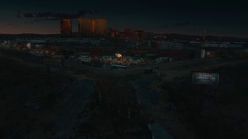 Movie still from “Army of the Dead” (2021), directed by Zack Snyder – An aerial view of a city at night with buildings lit up in the dark; Extreme Wide shot, High angle