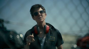 Movie still from “Army of the Dead” (2021), directed by Zack Snyder – A woman wearing headphones and smoking a cigarette; Close Up shot, Low angle