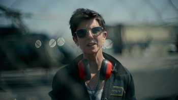 Movie still from “Army of the Dead” (2021), directed by Zack Snyder – A woman wearing a jacket and sunglasses with headphones on; Close Up shot, Over the shoulder angle