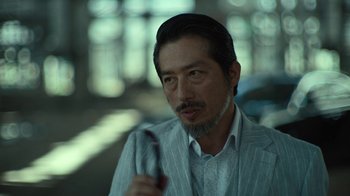 Movie still from “Army of the Dead” (2021), directed by Zack Snyder – A person holding a pen; Close Up shot, Low angle