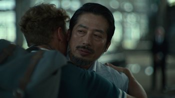 A person hugging another person