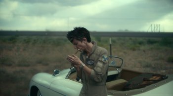 Movie still from “Army of the Dead” (2021), directed by Zack Snyder – A person standing in front of a motor bike; Medium shot, Over the shoulder angle