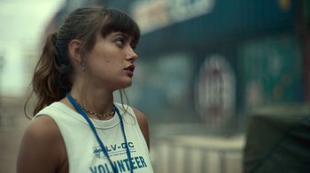 Movie still from “Army of the Dead” (2021), directed by Zack Snyder – A woman with a necklace standing in front of a building; Close Up shot, Low angle