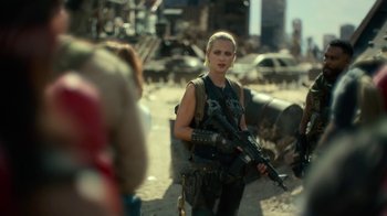 Movie still from “Army of the Dead” (2021), directed by Zack Snyder – A woman holding a gun while standing next to a pile of trash; Medium shot, Over the shoulder angle