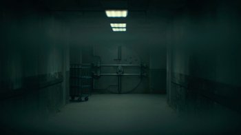 Movie still from “Army of the Dead” (2021), directed by Zack Snyder – An empty room with a large metal door; Extreme Wide shot, Low angle