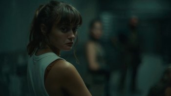 Movie still from “Army of the Dead” (2021), directed by Zack Snyder – A woman in a white shirt is looking at the camera; Close Up shot, Over the shoulder angle