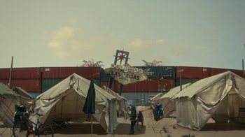 Movie still from “Army of the Dead” (2021), directed by Zack Snyder – A group of people walking in front of tents and palm trees; Extreme Wide shot, Low angle