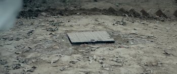 Movie still from “Article 15” (2019), directed by Anubhav Sinha – An empty plate sitting on top of a dirt field; Extreme Close Up shot, Overhead angle