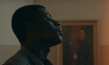 Movie still from “Atlantics” (2019), directed by Mati Diop – A person with his eyes closed; Close Up shot, Low angle