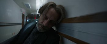 Movie still from “Bardo: False Chronicle of a Handful of Truths” (2022), directed by Alejandro G. Iñárritu – A man with long grey hair and a beard leaning against a wall; Close Up shot, Low angle