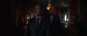 Movie still from “Bardo: False Chronicle of a Handful of Truths” (2022), directed by Alejandro G. Iñárritu – A man in a suit and a man in a suit and a tie; Medium shot, Low angle