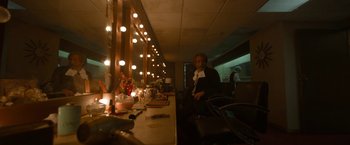 Movie still from “Bardo: False Chronicle of a Handful of Truths” (2022), directed by Alejandro G. Iñárritu – A woman sitting in front of a mirror in a dressing room; Wide shot, Low angle