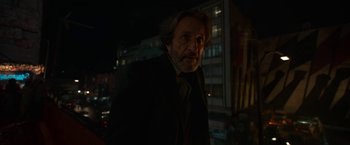 Movie still from “Bardo: False Chronicle of a Handful of Truths” (2022), directed by Alejandro G. Iñárritu – A man in a suit standing in the dark; Close Up shot, Low angle