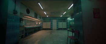 Movie still from “Bardo: False Chronicle of a Handful of Truths” (2022), directed by Alejandro G. Iñárritu – An empty room with a table and chairs in it; Extreme Wide shot, High angle