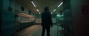 Movie still from “Bardo: False Chronicle of a Handful of Truths” (2022), directed by Alejandro G. Iñárritu – A man standing in a room with lights on the ceiling; Wide shot, Low angle