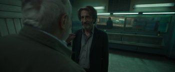 Movie still from “Bardo: False Chronicle of a Handful of Truths” (2022), directed by Alejandro G. Iñárritu – A man in a suit and tie standing next to another man in a suit and tie; Medium shot, Over the shoulder angle
