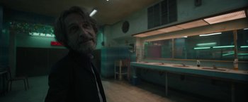 Movie still from “Bardo: False Chronicle of a Handful of Truths” (2022), directed by Alejandro G. Iñárritu – An older man standing in a room in a building; Medium shot, Over the shoulder angle