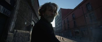 Movie still from “Bardo: False Chronicle of a Handful of Truths” (2022), directed by Alejandro G. Iñárritu – A person with long hair and a beard; Close Up shot, Low angle