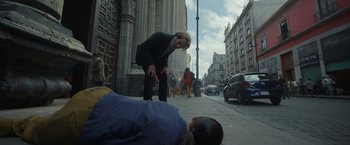 Movie still from “Bardo: False Chronicle of a Handful of Truths” (2022), directed by Alejandro G. Iñárritu – A woman standing on the side of the street next to a man; Wide shot, Low angle
