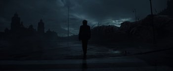 Movie still from “Bardo: False Chronicle of a Handful of Truths” (2022), directed by Alejandro G. Iñárritu – A person is walking on a wet street; Extreme Wide shot, Low angle
