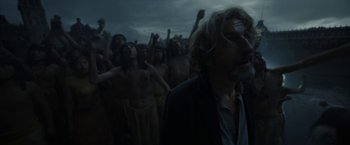 Movie still from “Bardo: False Chronicle of a Handful of Truths” (2022), directed by Alejandro G. Iñárritu – A group of people standing in the dark; Medium shot, Low angle