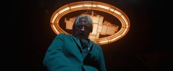 Movie still from “Bardo: False Chronicle of a Handful of Truths” (2022), directed by Alejandro G. Iñárritu – An older man in front of an illuminated sign; Medium shot, Low angle