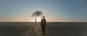 Movie still from “Bardo: False Chronicle of a Handful of Truths” (2022), directed by Alejandro G. Iñárritu – A man standing in the middle of an empty field; Extreme Wide shot, Low angle
