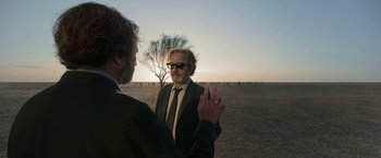 Movie still from “Bardo: False Chronicle of a Handful of Truths” (2022), directed by Alejandro G. Iñárritu – Two men standing in the middle of an open field; Medium shot, Over the shoulder angle