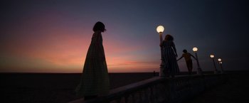 Movie still from “Bardo: False Chronicle of a Handful of Truths” (2022), directed by Alejandro G. Iñárritu – Two women are standing on a pier at sunset; Extreme Wide shot, Low angle