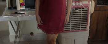 Movie still from “Badhaai Do” (2022), directed by Harshavardhan Kulkarni – A woman in a red dress standing in front of a building; Medium shot, High angle