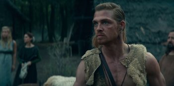 Movie still from “Barbarians” (2020), created by Arne Nolting – A person with long blonde hair; Close Up shot, Over the shoulder angle