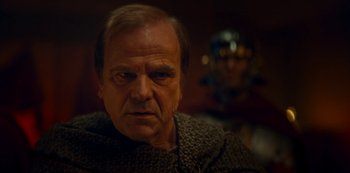 Movie still from “Barbarians” (2020), created by Arne Nolting – An older man is looking at the camera; Close Up shot, Over the shoulder angle