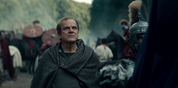 Movie still from “Barbarians” (2020), created by Arne Nolting – An older man wearing a blanket and a cape; Close Up shot, Low angle