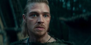 Movie still from “Barbarians” (2020), created by Arne Nolting – A person with long blonde hair; Close Up shot, Low angle