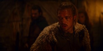 Movie still from “Barbarians” (2020), created by Arne Nolting – A person with a beard wearing a fur coat; Close Up shot, Over the shoulder angle