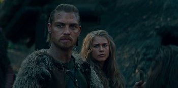 Movie still from “Barbarians” (2020), created by Arne Nolting – A man and a woman standing next to each other; Close Up shot, Over the shoulder angle