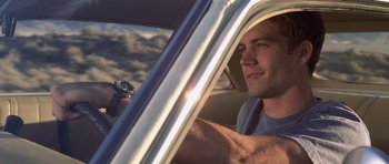 Movie still from “Joy Ride” (2001), directed by John Dahl – A man sitting in the driver's seat of a car; Close Up shot, Over the shoulder angle