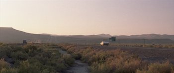 Movie still from “Joy Ride” (2001), directed by John Dahl – A truck driving down a road in the middle of a desert; Extreme Wide shot, High angle