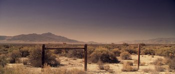 Movie still from “Joy Ride” (2001), directed by John Dahl – An old fence in the middle of a barren desert landscape; Extreme Wide shot, Low angle